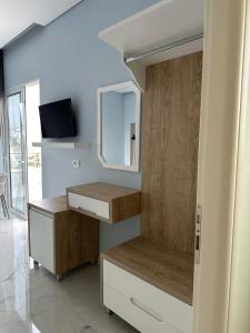 a bathroom with a sink and a mirror and a cabinet at Summer Gate Hotel in Ksamil