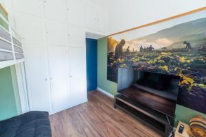 a living room with a large flat screen tv at La maison Grand Cru in Arveyres