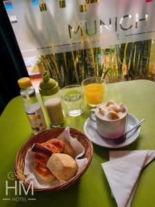a table with a plate of bread and a cup of coffee at HOTEL HM in Córdoba