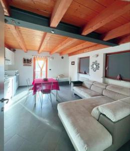 a living room with a couch and a table at CasaSolar Saintchristophe a 2 minuti da Aosta in Aosta