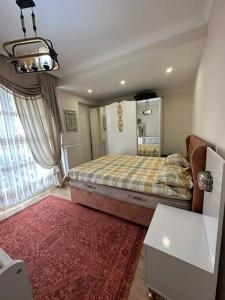 a bedroom with a large bed and a red rug at شقة باطلالة على البحر in Istanbul