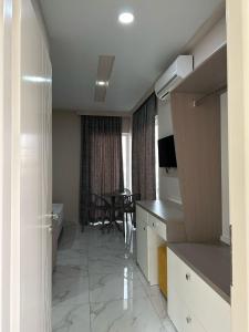 a room with a kitchen and a dining room at Summer Gate Hotel in Ksamil