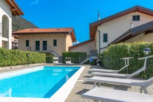 a swimming pool in front of a house at Apartment Alice - Tremezzina in Lenno