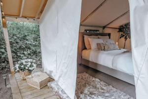 a bedroom with a bed in a tent at The Eagle's Nest in Delta