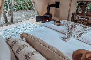 a bedroom with a bed with a stove in it at The Eagle's Nest in Delta