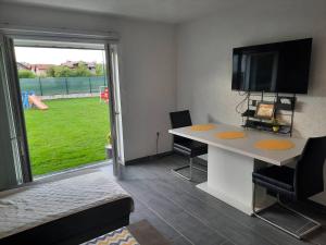 a room with a desk with a tv and a window at The Bosna River in Vreoca