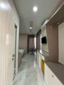 a room with a kitchen and a living room at Summer Gate Hotel in Ksamil