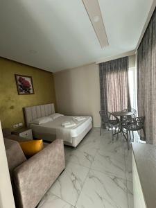 a hotel room with a bed and a table at Summer Gate Hotel in Ksamil