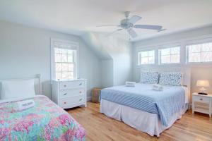 a bedroom with two beds and a ceiling fan at Walk to Oyster Pond and Main Street Chatham in Chatham