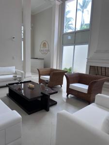 a living room with couches and a coffee table at Enseada Premium Suítes in Guarujá