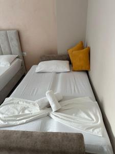 two beds sitting next to each other in a room at Summer Gate Hotel in Ksamil