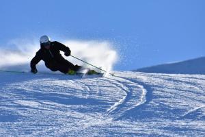 a man is skiing down a snow covered slope at Rifugio Baita Gimont in Cesana Torinese