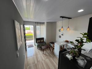 a living room with a desk and a chair at Rio Aparta-Hotel 4 in Leticia