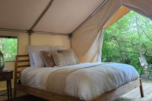 a bedroom with a bed in a tent at The Fox Den in Delta
