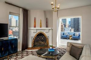 a living room with a couch and a fireplace at Hotel Adagio, Autograph Collection in San Francisco