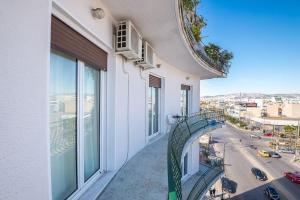 a balcony of a building with a view of a street at Athens 360 Acropolis View Apartment in Athens