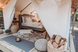 a bedroom with a bed in a tent at The Raven Lounge in Delta
