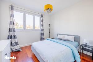 a white bedroom with a bed and a window at Beau T3-résidence calme-proche Paris/La Défense in Suresnes