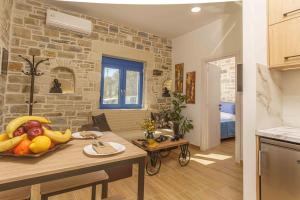 a kitchen with a table with a bowl of fruit on it at Bellus Residence! in Ambeloúzos