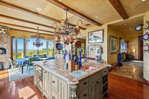 a kitchen with a large center island in a room at Malibu by the Sea - 5-STARS! in Solromar