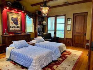 a bedroom with two beds and a chair in it at Malibu by the Sea - 5-STARS! in Solromar