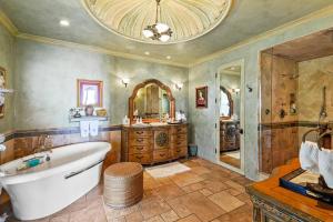 a large bathroom with a tub and a mirror at Malibu by the Sea - 5-STARS! in Solromar +68 photos