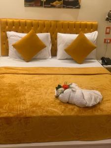 a bed with a towel with flowers on it at Salvatore Room With Simple Breakfast- Al Dokki in Cairo
