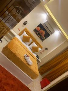 a bedroom with a bed with aroll at Salvatore Room With Simple Breakfast- Al Dokki in Cairo