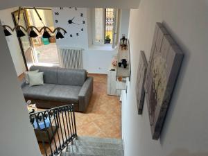 a living room with a couch and a staircase at Dream Holiday in Argegno +37 photos
