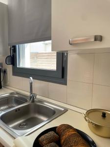 a kitchen with a sink and a plate of bread at Casa de Manu in Rhodes Town +29 photos