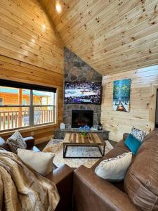 a living room with a couch and a fireplace at New! Indoor Pool/PS 5/Hot tub/Parkway in Pigeon Forge
