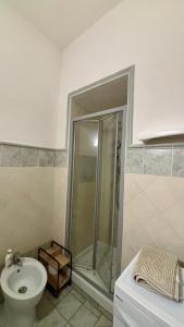a bathroom with a shower and a toilet and a sink at Casa Gialla in Canino