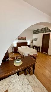 a large bedroom with a bed and a table at Casa Gialla in Canino +12 photos