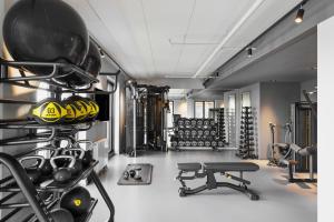 a gym with a rack of helmets and weights at Fairfield by Marriott Copenhagen Nordhavn in Copenhagen