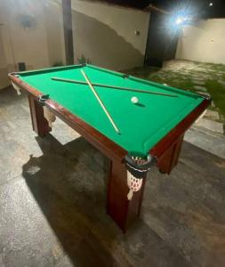 a green pool table with a ball on it at Casa Completa, muito bem localizada ! in Búzios