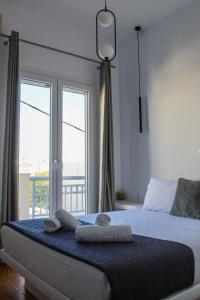 a bedroom with a bed with towels on it at Aeolian Breeze 2 in Tinos +13 photos