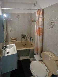 a bathroom with a sink and a toilet and a tub at Aeolian Breeze 2 in Tinos