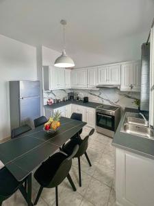 a kitchen with a table with chairs and a sink at Aeolian Breeze 2 in Tinos