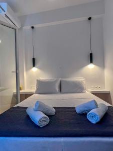 a bedroom with a bed with two pillows on it at Aeolian Breeze 2 in Tinos