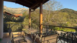 a patio with a table and chairs on a balcony at Villa Bellissimo in Skala Potamias