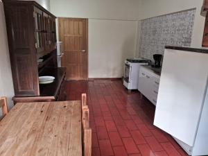 a kitchen with a wooden table and a white board at Chalés Vill'Agi in Campos do Jordão +39 photos