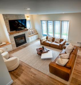 a living room with a couch and a fireplace at New Farmhouse, King Beds, Game Room, Hot Tub & View! in Montgomery
