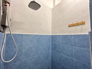 a bathroom with a shower with blue tiles at Melaka jonker street kids friendly guesthouse Malacca in Melaka