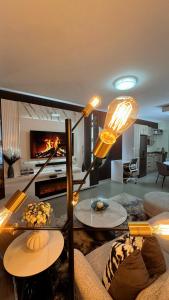 a living room with a couch and a fireplace at D&DLuxury Rivonia Apartments with inverter in Johannesburg