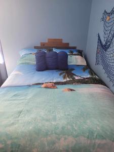 a bedroom with a bed with a painting on it at Maggie's Cozy Corner in Wimauma