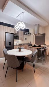 a kitchen with a white table and chairs at D&DLuxury Rivonia Apartments with inverter in Johannesburg