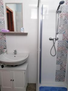 a bathroom with a sink and a shower at Donna Concetta in Patti