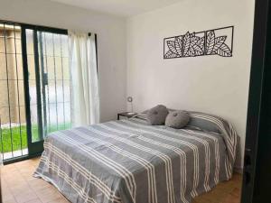 a bedroom with a bed with two stuffed animals on it at Caminos del vino: Piscina,Bicis,Parrilla in Maipú +44 photos