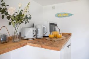 a kitchen counter with two glasses of orange juice at Little Highfield in Kingsbridge