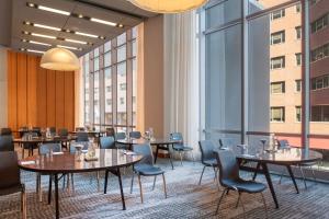 a restaurant with tables and chairs and large windows at W Boston in Boston